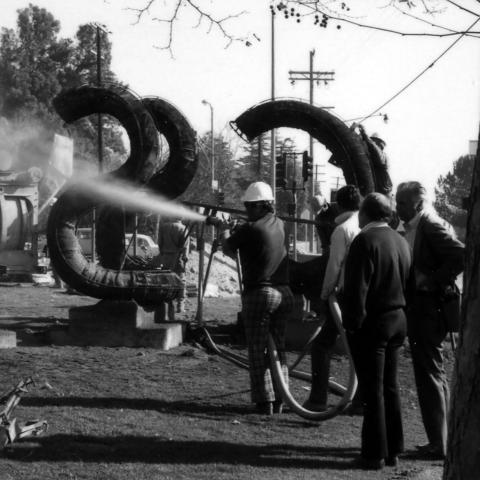 Member of Banks’ crew spraying concrete onto the frame of the sculpture