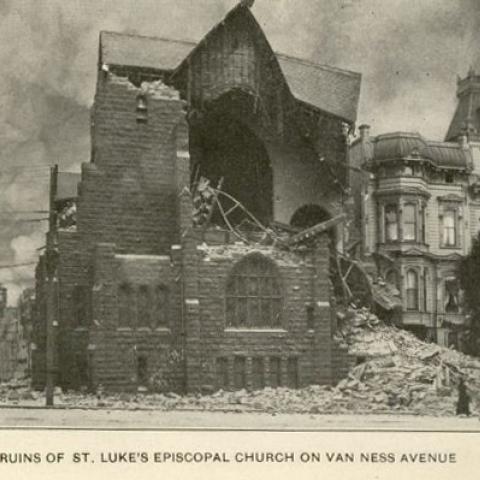 Photograph of a crumbled St. Luke's Episcopal Church with smoke in the background, in San Francisco’s Great Disaster