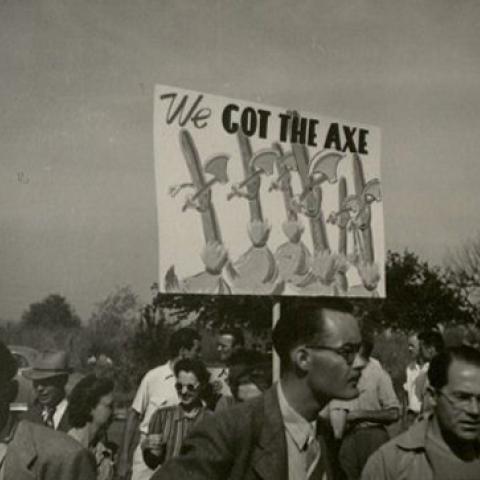Protester with sign that reads, "We got the axe"
