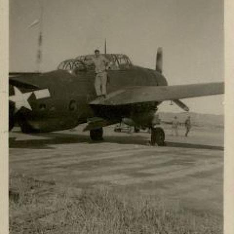 Ellwood Lawson standing on a Torpedo Bomber at West Airfield, Peiping, China, 1945-1946