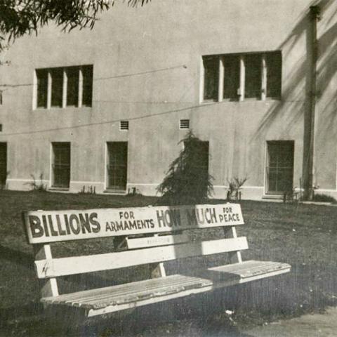 Anti-war advertisement on public bench, Billions for Armaments, How Much for Peace
