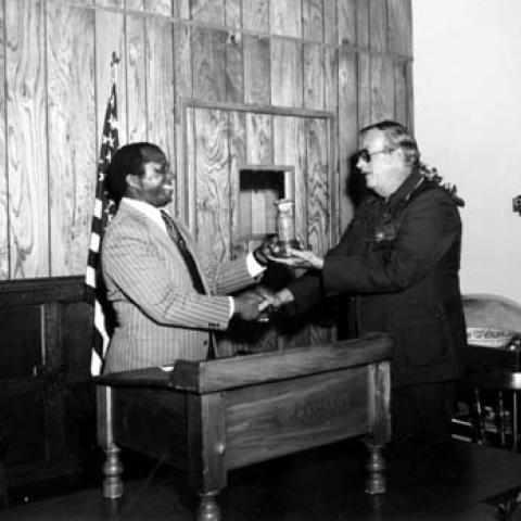 Raymond Carter receives a gavel as the new Toastmasters president, 1977