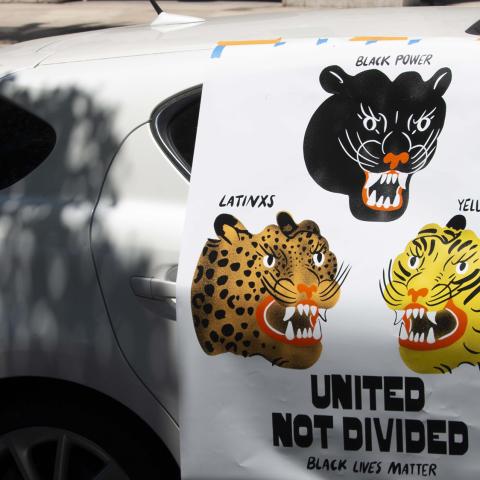 Vehicle displays poster which reads "United not divided - Black Lives Matter'', at Liberty Park during a "Ktown for Black Lives" event, Koreatown, 2020, KRT.D.B1.11.3494 