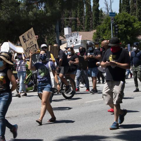 Protesters march down the street holding handmade posters during a Black Lives Matter March. Northridge, 2020, KRT.D.B1.6.2839 