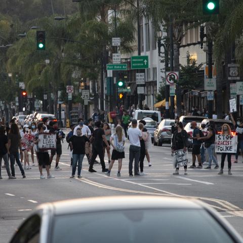 Unidentified individuals hold handmade posters as they gather in the street during a demonstration Pasadena, 2020, KRT.D.B1.19.3421