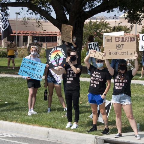 Unidentified individuals hold handmade posters during a demonstration in honor of Breonna Taylor held near Tapo Canyon and Alamo Street, Simi Valley, 2020, KRT.D.B1.9.4627