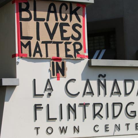 Posters taped to La Cañada town shopping center sign read "Black Lives Matter" and "in" at the Rally for Black Lives eventLa Cañada, 2020, KRT.D.B1.15.4769 