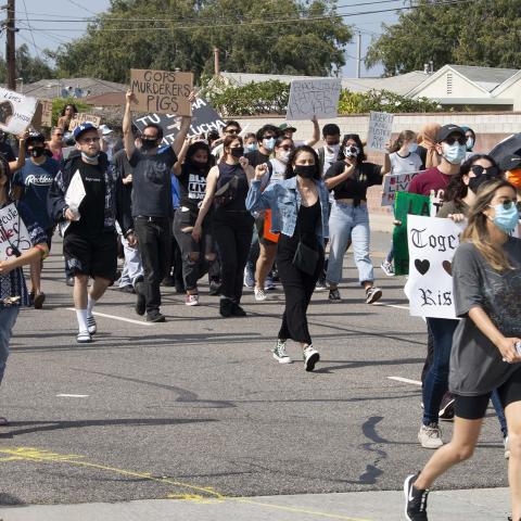 Unidentified individuals march down the street during a protest to Defund the Police at Del Aire Park. Hawthorne, 2020, KRT.D.B1.4.3106