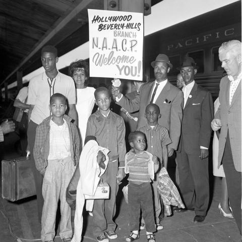 A Louisiana family posing with a sign that reads “Hollywood Beverly-Hills NAACP Welcome You!” Harry Adams Collection. A Louisiana family posing with a sign that reads “Hollywood Beverly-Hills NAACP Welcome You!” Harry Adams Collection.