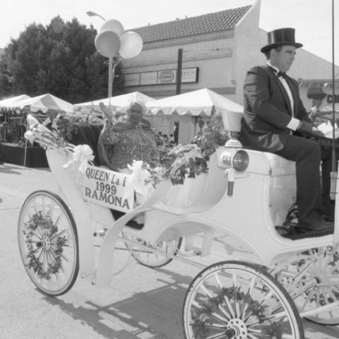 Queen of the 1999 LALA Mardi Gras, Ramona, waves by as she rides a decorated carriage. Calvin Hicks Collection. Queen of the 1999 LALA Mardi Gras, Ramona, waves by as she rides a decorated carriage. Calvin Hicks Collection.