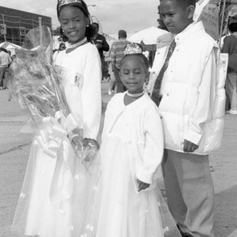 Children dressed in formal clothing and tiaras as a part of 1999 LALA Mardi Gras, in Leimert Park. Calvin Hicks Collection.  Children dressed in formal clothing and tiaras as a part of 1999 LALA Mardi Gras, in Leimert Park. Calvin Hicks Collection.