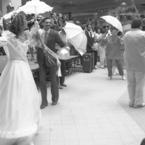Community members dance in traditional New Orleans regalia inside the Baldwin Hills Mall,1990. Roland Charles Collection.  Community members dance in traditional New Orleans regalia inside the Baldwin Hills Mall,1990. Roland Charles Collection.