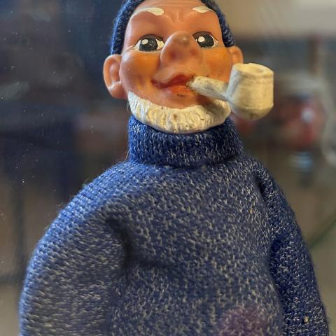 Wooden sailor of man with beard smoking a pipe, wearing knit sweater and cap; Pavel Ilyin Soviet Sailors Collection