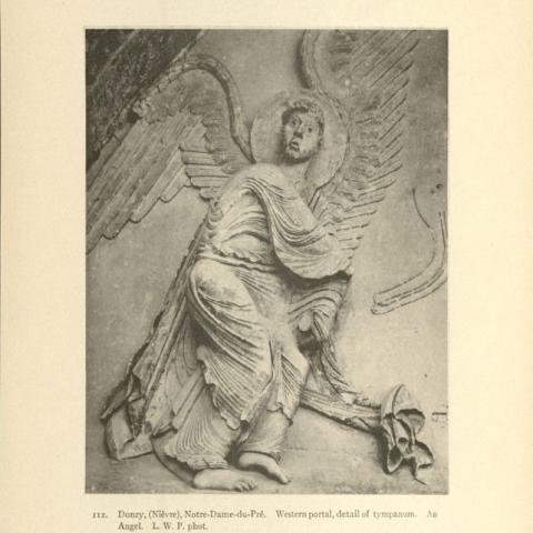 Angel carved on the tympanum of Notre-Dame-du-Pré