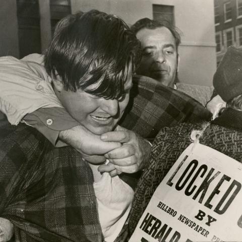 Striker applying choke hold to scab crossing the picket line