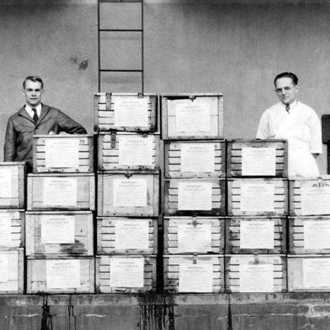 Plant Superintendent L. F. Krehbiel and Laboratory Director Joseph Wenger ready milk for a delivery to President Roosevelt on the U. S. S. Houston, 1936