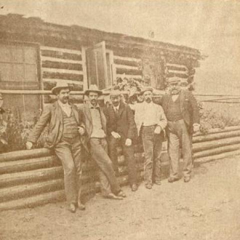 Five men next to a cabin. Sam Hayes Scrapbook