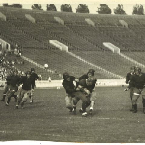 Scrapbook page photograph of Occidental College football players in action, ca. 1920s