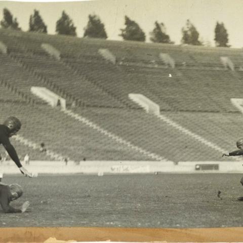 Scrapbook page photograph of Occidental College football players in action, ca. 1920s