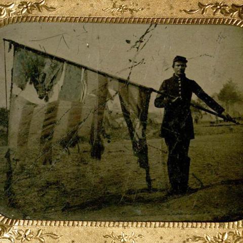 Union soldier with tattered US flag