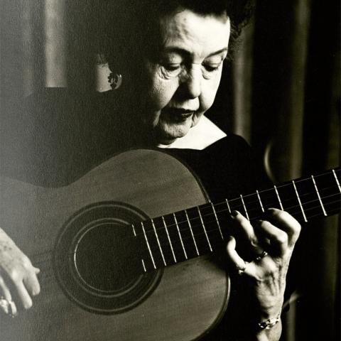 Photo of Vahdah Olcott-Bickford playing guitar