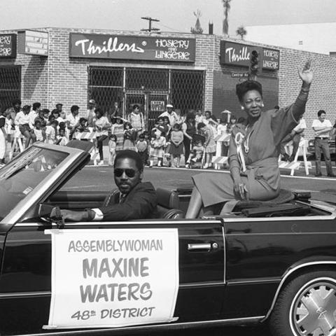 State Assemblywoman Maxine Waters waves to spectators from the back of a convertible during the 16th annual South Central Easter Parade along Vernon and Central Avenues in Los Angeles. 1986. Digital ID: 11.06.GC.N35.B22.12.76.10A