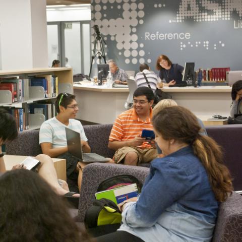 Librarians at the new reference desk, and students enjoying our new furniture.