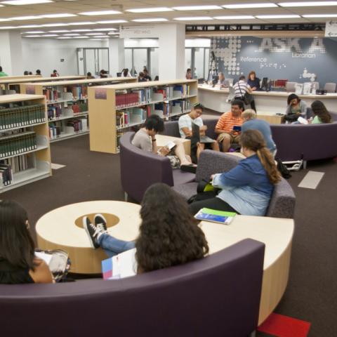 Librarians at the new reference desk, and students enjoying our new furniture.