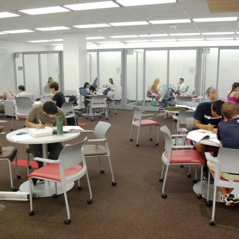 Movable furniture, glass walled group study and whiteboard walls.