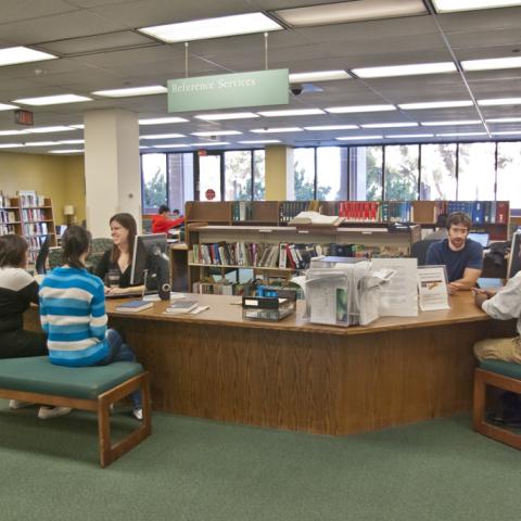 Students getting research help at the old reference desk.