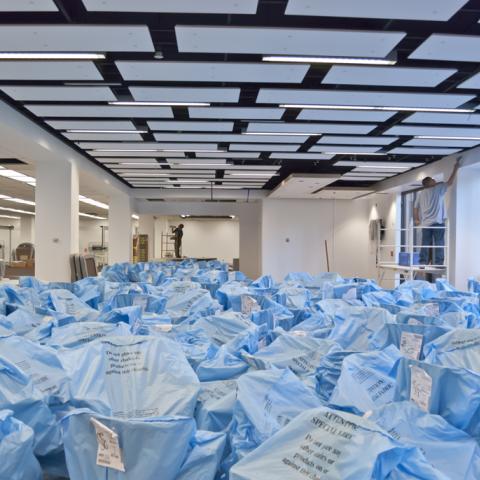 Blue plastic covers our new furniture, and our new ceilings and lights are installed.