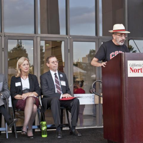 Provost Hillenbrand takes the podium at the Grand Opening.