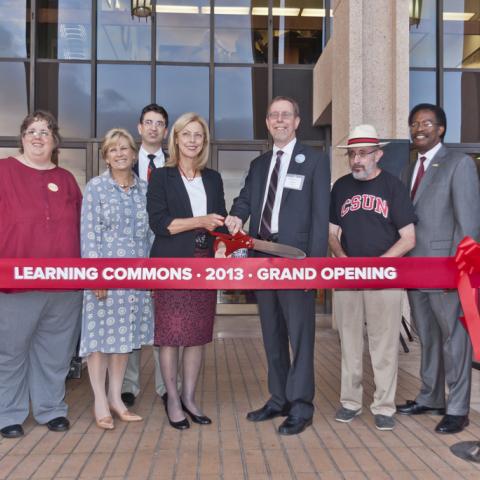 President Harrison and Dean Stover with staff, poised for the ribbon-cutting ceremony.