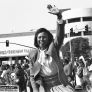 Yvonne Burke waving in front of Baldwin Hills Crenshaw Plaza during the Kingdom Day parade. 1992. Guy Crowder Collection. Digital ID: 11.06.GC.N35.B5.47.158.34A