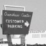 Exterior view of the former Crenshaw Center, with a sign for customer parking and the Broadway department store building still intact, circa 1980-1988. Roland Charles Collection..