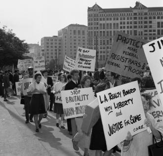 People walking down the street protesting.