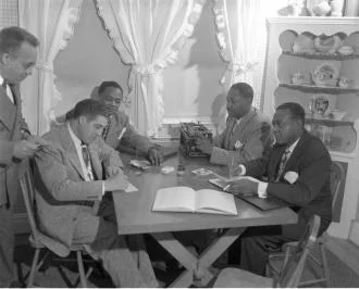 A group of men sitting on a table.