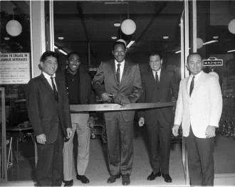 A group of men posing for an inauguration ceremony ribbon cutting.