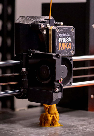 Closeup view of a 3D printer's head.