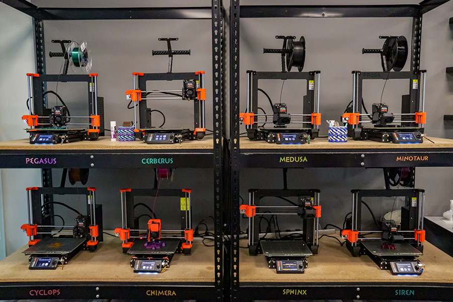 3D printers on shelfs.