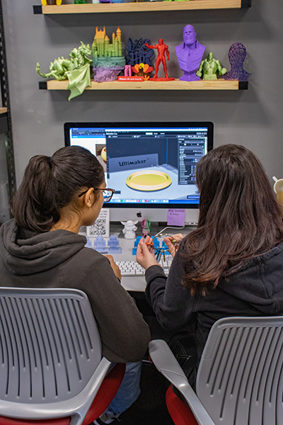 2 students working in front of a computer