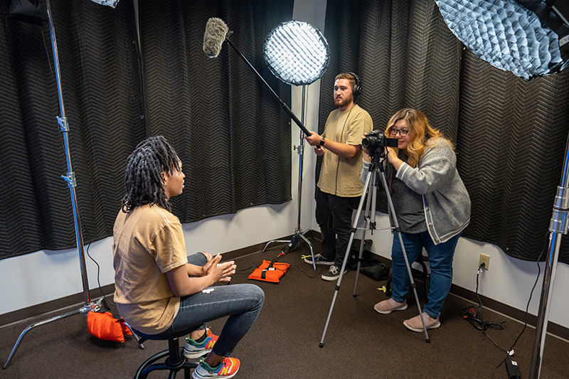 Student working with audio recording equipment