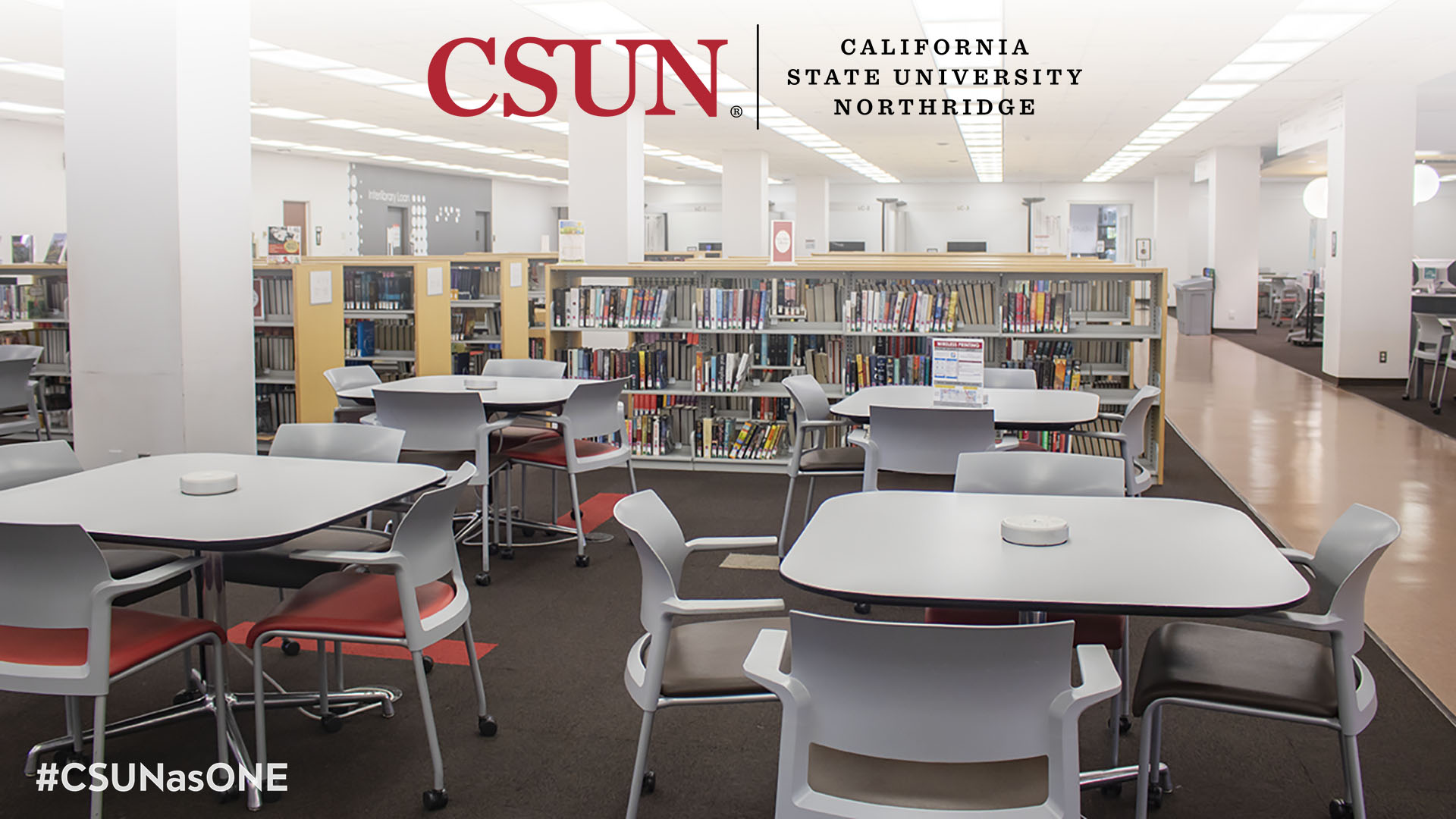 tables and chairs in front of short reference stacks