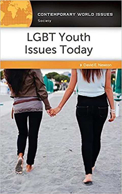 Two girls walking across the sand holding hands