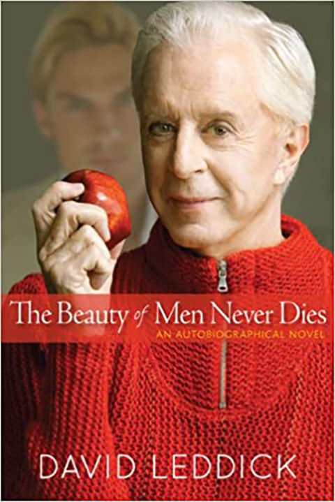 An older man holding a red apple
