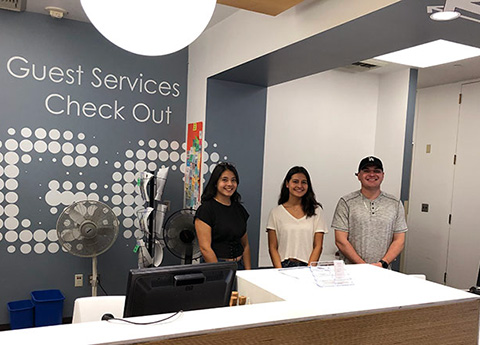 Student workers at the Guest Services desk at CSUN's University Library