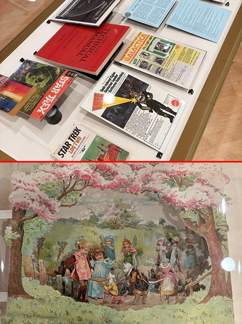 Exhibit case with Science Fiction materials. Pop up fairy book in the Journeys of the Imagination exhibit