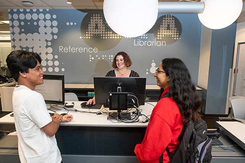 Students and Librarian Brianna Limas at the Reference Desk