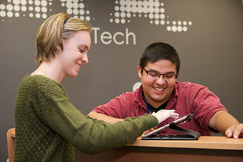 Campus IT helping a student in the Oviatt Library Learning Commons