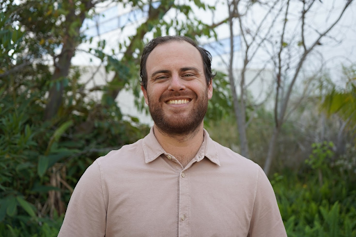 Profile of Jacob Hinkel-Lipsker wearing a brown dress shirt amid the outdoors